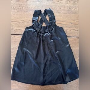 Black cross back silky top with pockets. In perfect condition. Only worn once.